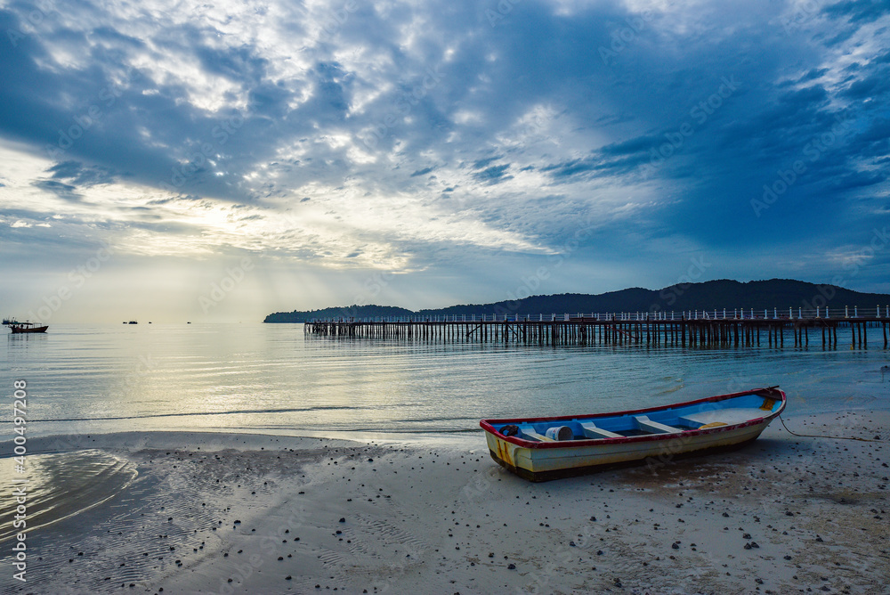 beautiful landscape of the blue sky, wooden boat, wooden bridgeon the Kohrong Samloem beach at Cambodia