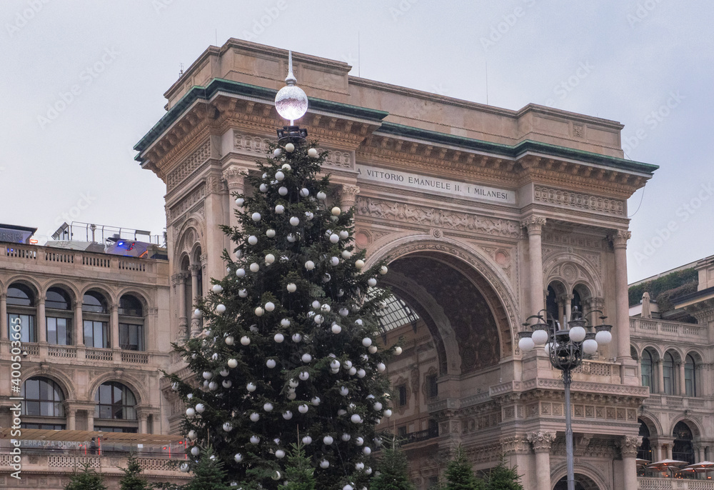 entrance into the Vittorio Emanuele gallery decorated with a large Christmas tree. Duomo Square, Milan, Italy