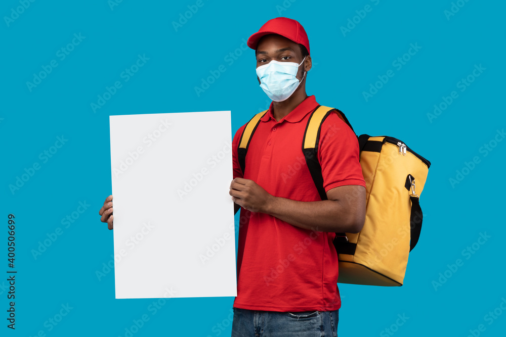 Black delivery guy holding blank white advertising board Black delivery guy holding blank white advertising board