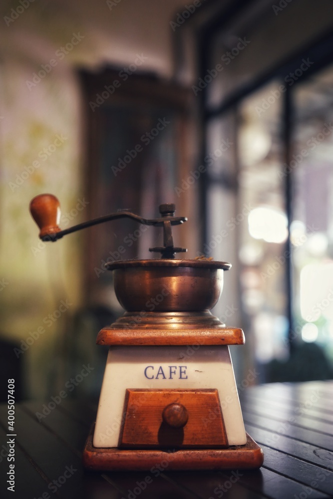 An old coffee grinder on the table An old coffee grinder on the table