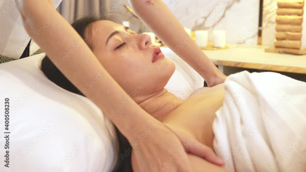 Asian Beautiful, young and healthy woman in spa salon. Massage treatment spa room  . Traditional medicine and healing concept.
