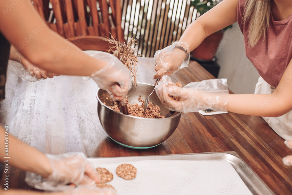 Fototapeta premium Girls bake oatmeal cookies at home
