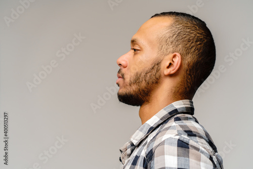 african-american young man wearing casual shirt over light grey background