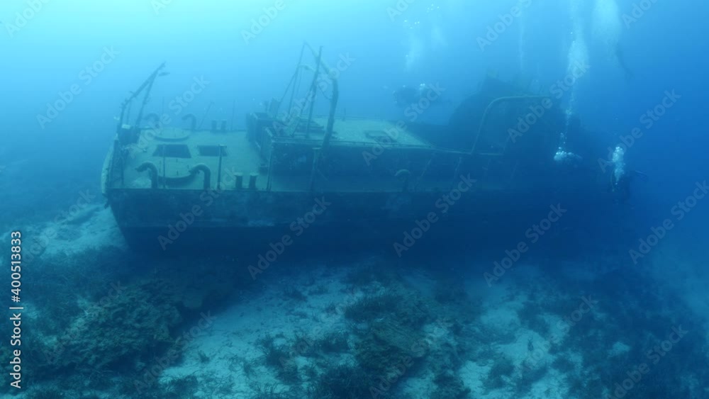 scuba divers exploring shipwreck scenery underwater ship wreck deep blue water ocean scenery of metal underwater scuba divers exploring shipwreck scenery underwater ship wreck deep blue water ocean scenery of metal underwater