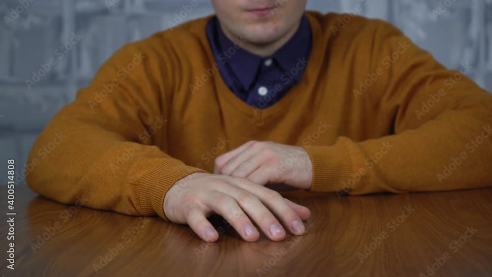 a man sitting at the table bangs his fingers on the table due to stress a man sitting at the table bangs his fingers on the table due to stress