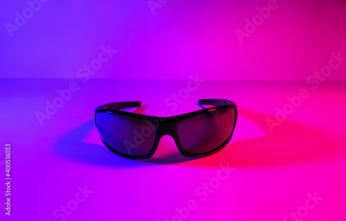 sun safety glasses in neon light, ultraviolet, photo taken in a photo studio 5