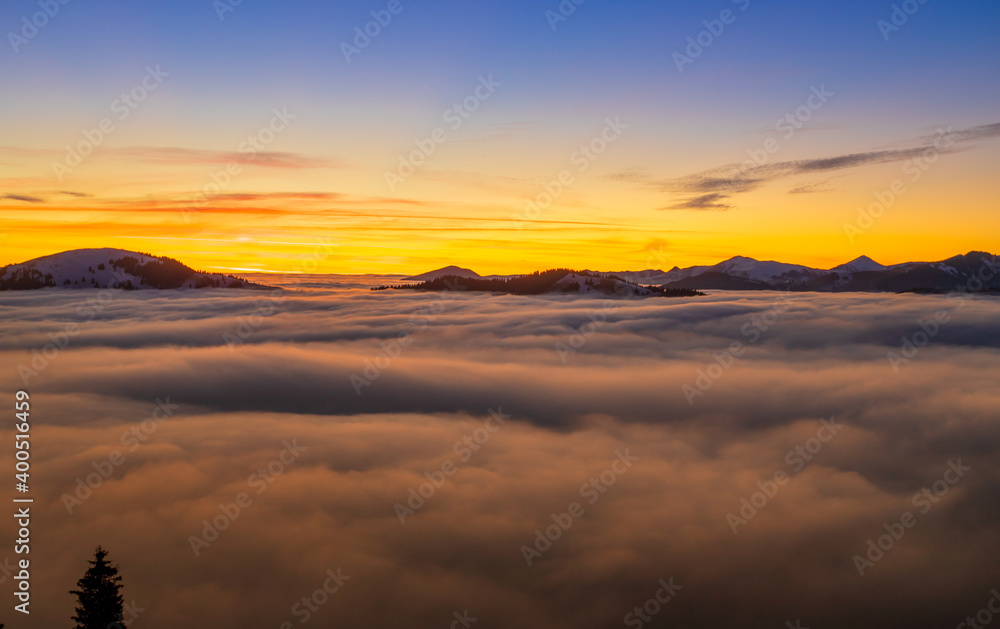 Obraz premium Beautiful sunset over sea of clouds. Winter landscape