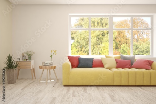 Modern room in illuminating yellow color with sofa and autumn landscape in window. Scandinavian interior design. 3D illustration © AntonSh