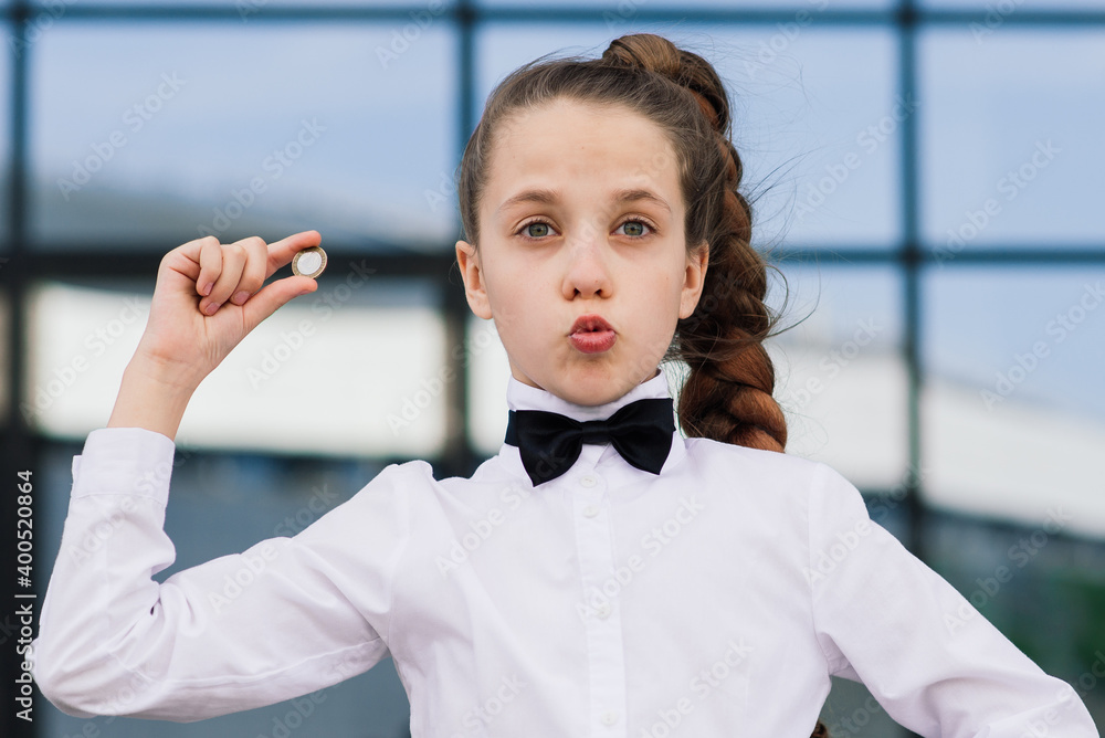 Portrait of cute caucasian teen girl holding coin. Saving money concept. Portrait of cute caucasian teen girl holding coin. Saving money concept.