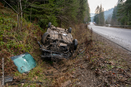 The Car Got Into an Accident on the Mountain Road and fell Upside Down. The Blue Car Turned over in a Ditch near the Highway