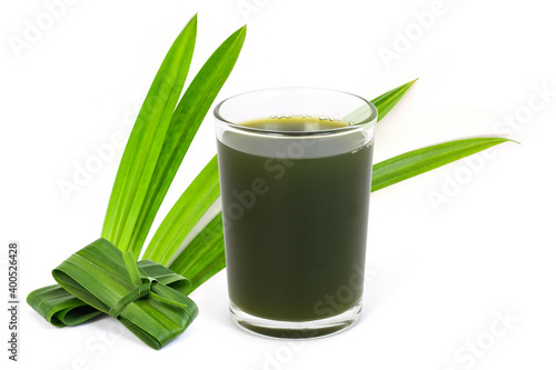 fresh green pandan leaves and glass of pandan juice tea isolated on white background .