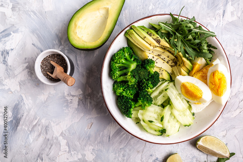 Buddha bowl with avocado, cucumber, arugula, lime and broccoli. vegetarian food concept. Long banner format. space for text