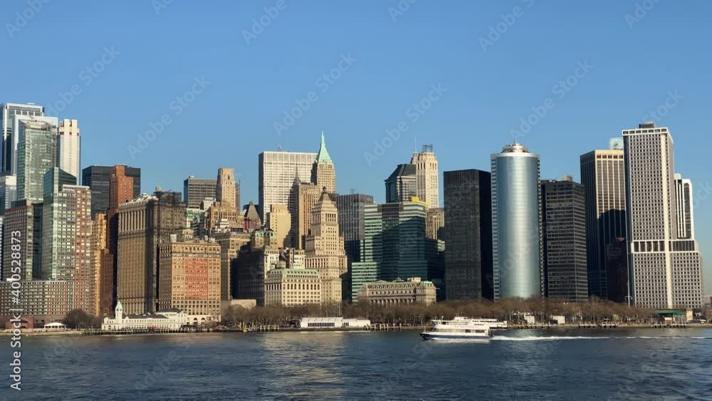 Downtown Manhattan on a sunny day, Battery Park, Busy harbour, ferries passing by Downtown Manhattan on a sunny day, Battery Park, Busy harbour, ferries passing by