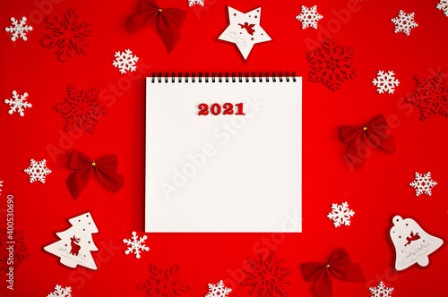 New Year 2021. Christmas greeting backgrounds. Holiday gifts and Christmas sales. The symbol of the year of the bull on a red background with elegant sparkling ornaments and snowflakes.