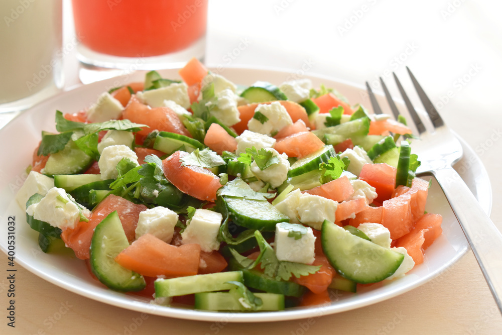 Cucumber and tomato salad with feta cheese.  Greek style salad.  Healthy and dietary food.  Weight loss program meal.