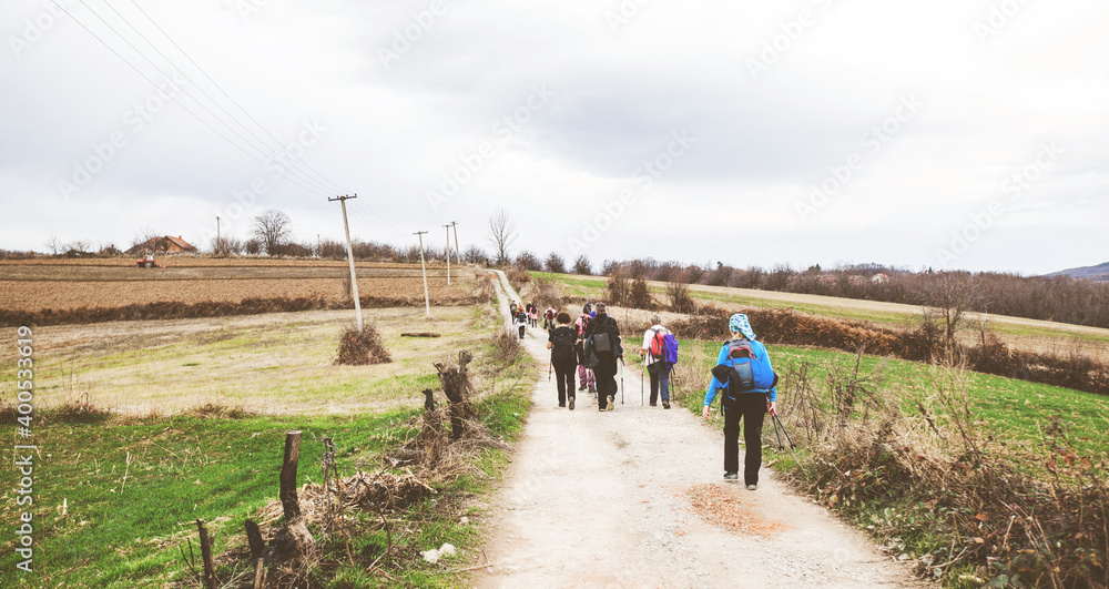  active people trekking on rural landscape