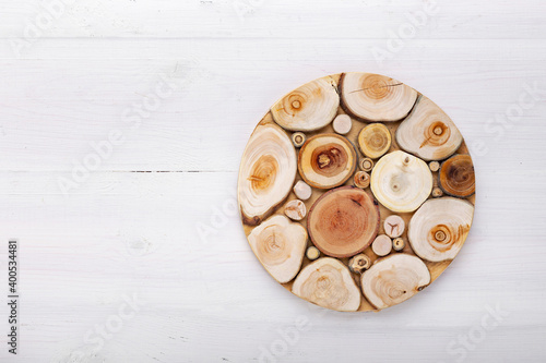 Empty round cutting board on a white wooden table.