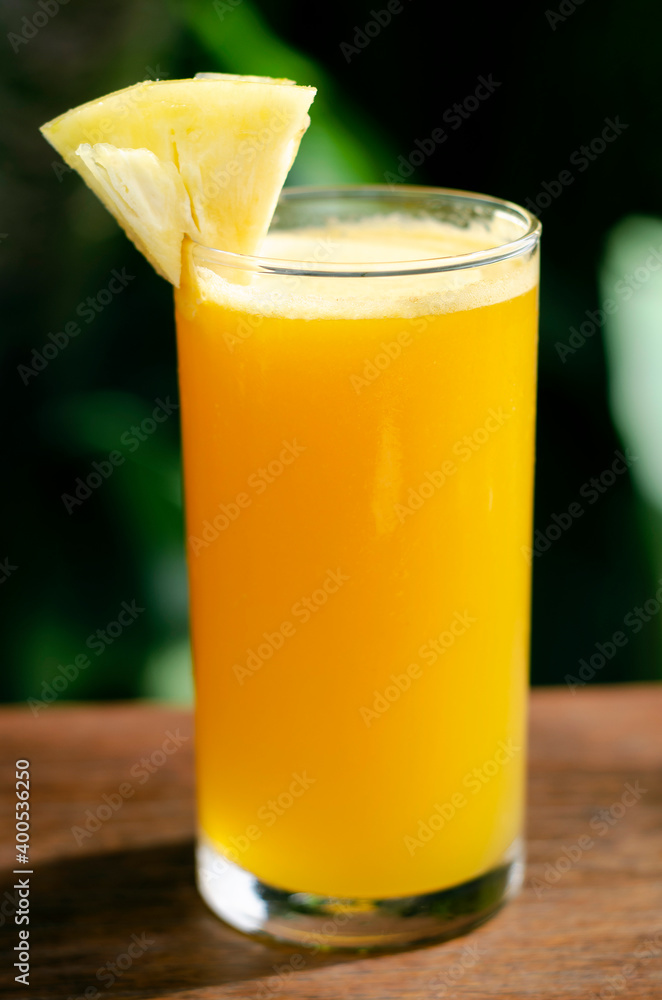 glass of fresh organic pineapple juice on table outdoors glass of fresh organic pineapple juice on table outdoors
