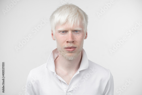 Fotografija portrait of an albino man in  studio dressed t-shirt isolated on a white background