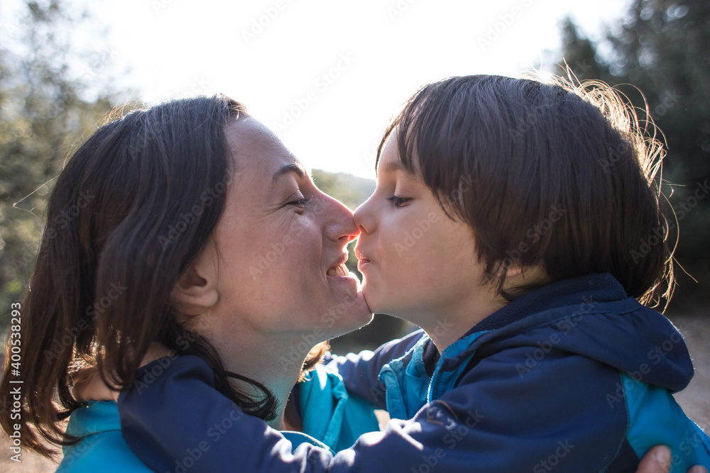 Fototapeta premium Child and mother touch their noses.