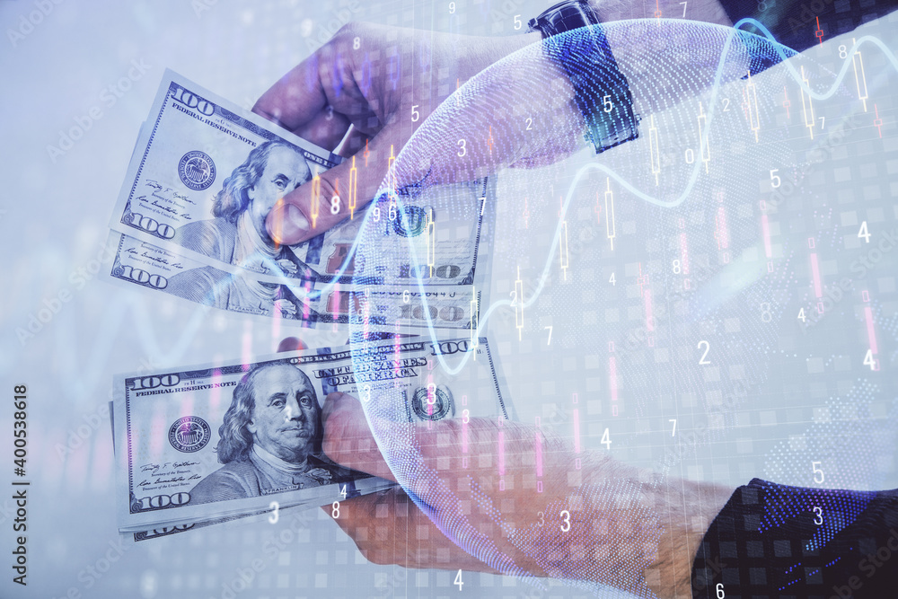 Multi exposure of financial graph drawing hologram and USA dollars bills and man hands. Analysis concept.