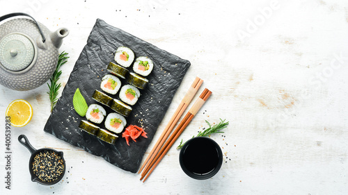 Sushi rolls with avocado and salmon. Classic Japanese sushi. Top view. Free space for your text.