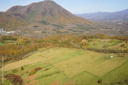 Autumn mountains with plain green field in Rusutsu, Hokkaido, Japan, aerial view - 紅葉した景色 羊蹄山 ルスツ 北海道虻田郡留寿都村