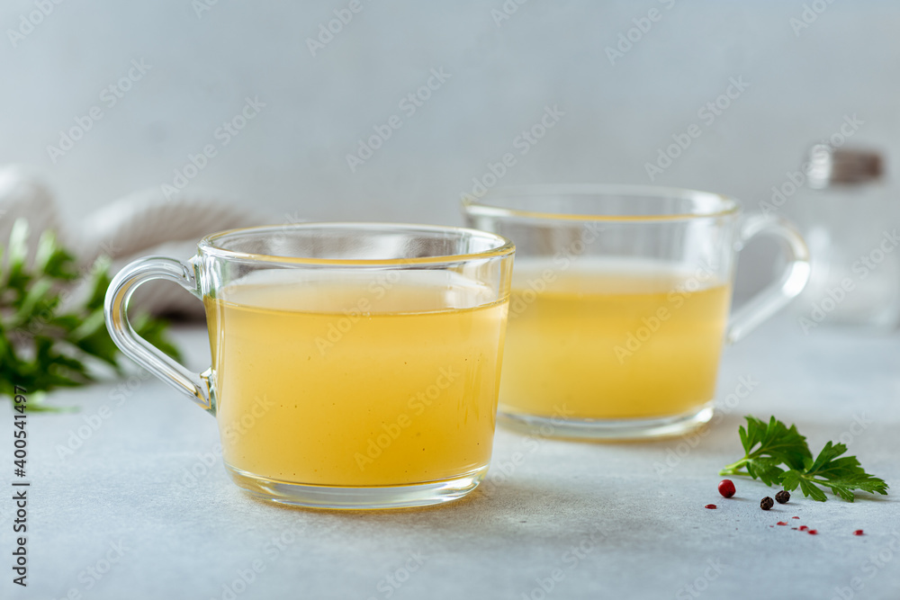 bone broth in a glass cup on a light background, selective focus bone broth in a glass cup on a light background, selective focus