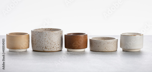 Photo handmade ceramics, empty craft ceramic bowls on light background