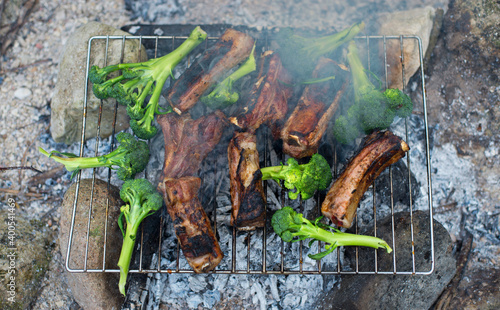 Pork ribs cooked on the grill with broccoli.