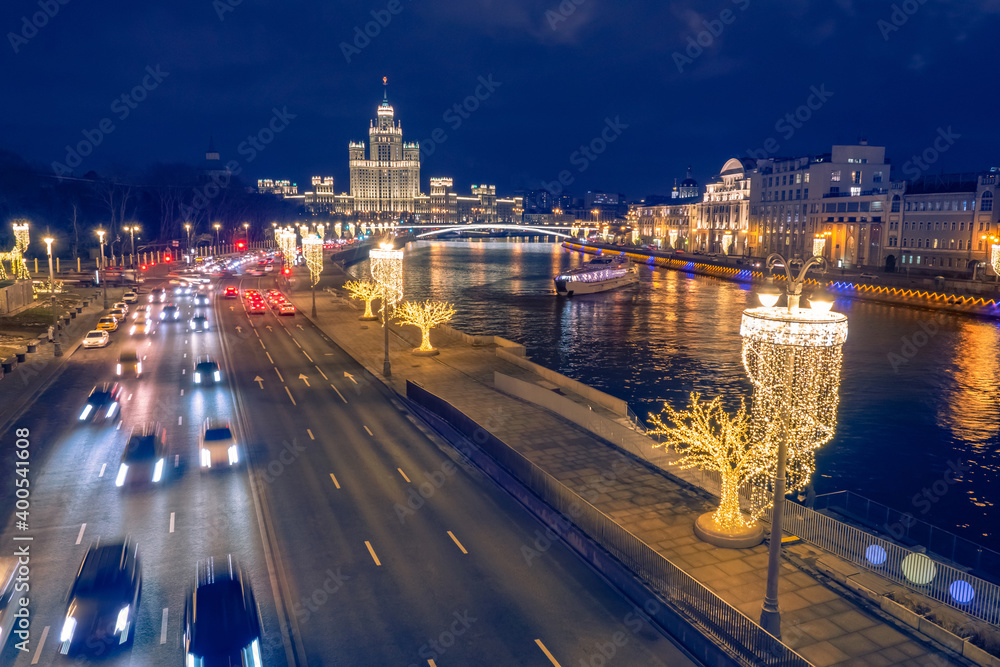 Moscow. Russia. New Year's Moscow from the Quadcopter. Highway along the Moscow River. Cars drive on a night road. Christmas capital. New Year in the cities of Russia. Christmas illumination
