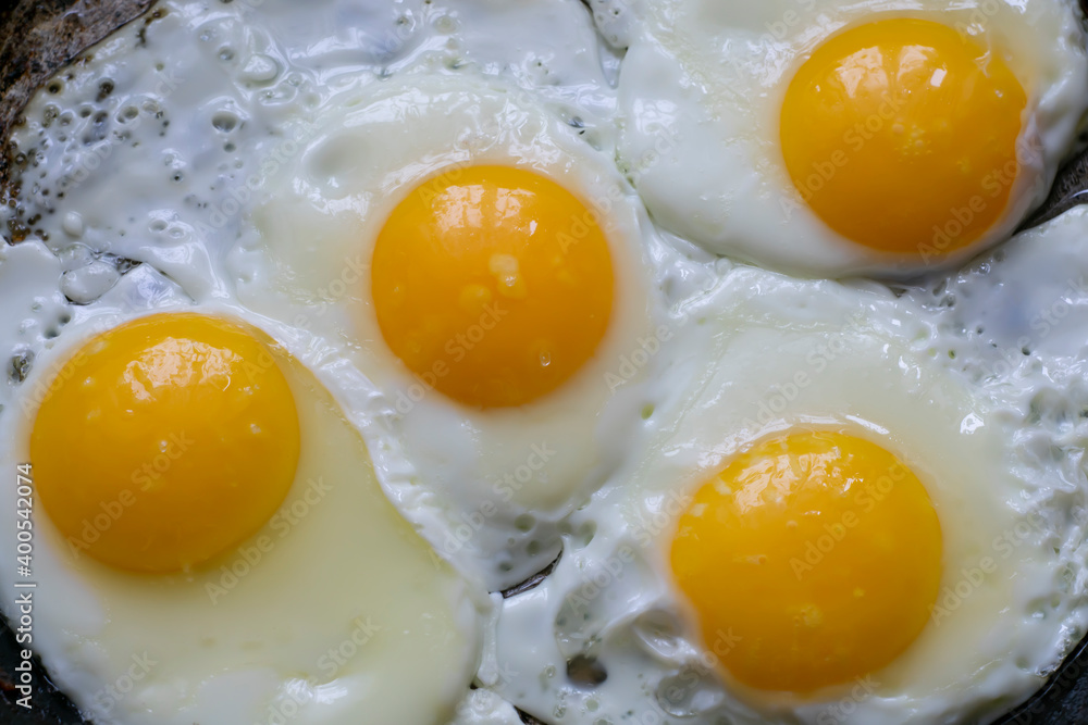 Fried chicken eggs in a pan. Close-up.
Fried chicken eggs in a pan. Close-up.