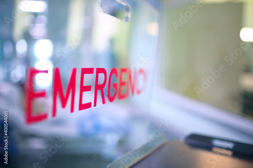 Transparent plastic divider on the reception desk in the hospital admission department with red lettering emergency photo