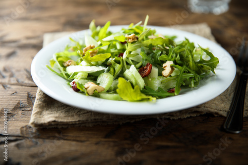Healthy arugula salad with celery and walnut