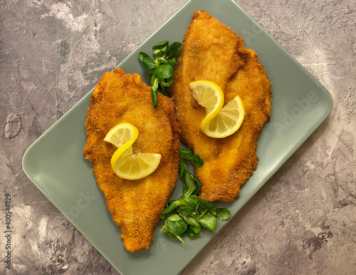 Fototapet Classic breaded plaice fish fillets, coated in flour, egg, breadcrumbs and fried in oil to golden