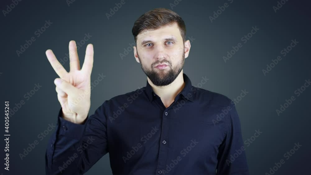 man in shirt shows countdown with hand gestures man in shirt shows countdown with hand gestures