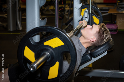 Young athlete men has fit training with barbell in the gym