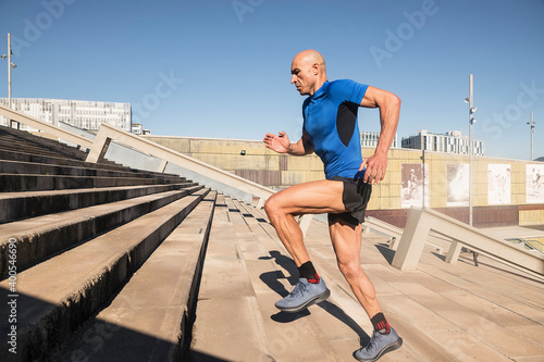Sportsman running up stairs in a urban landscape © carlesiturbe