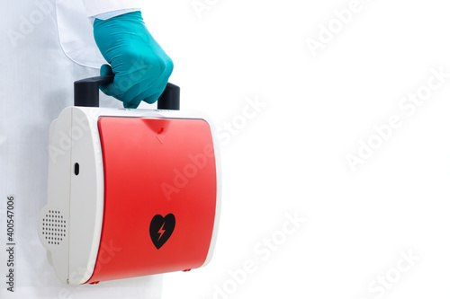 Aed rescue equipment Or a red heart defibrillator In the doctor's hand White background photo