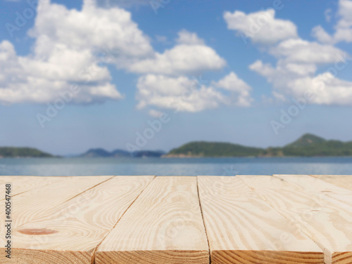 wooden table in front of abstract blurred in view of the sea background