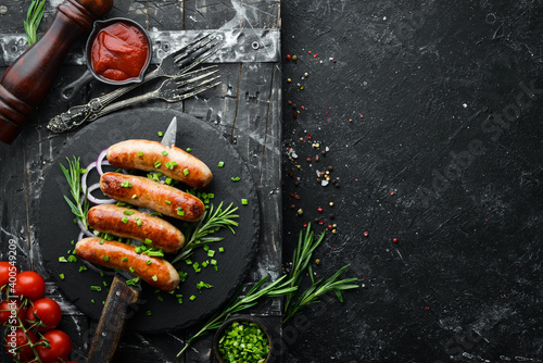 Grilled barbecue sausages with rosemary and spices. Top view. Free space for your text.