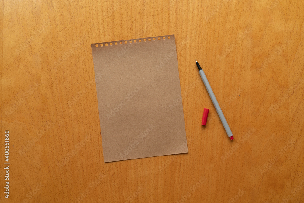 craft paper and red pencil on wooden table background, isolated. taking note. blank paper. new year's resolution, goals. 2021. copy space. craft paper and red pencil on wooden table background, isolated. taking note. blank paper. new year's resolution, goals. 2021. copy space.