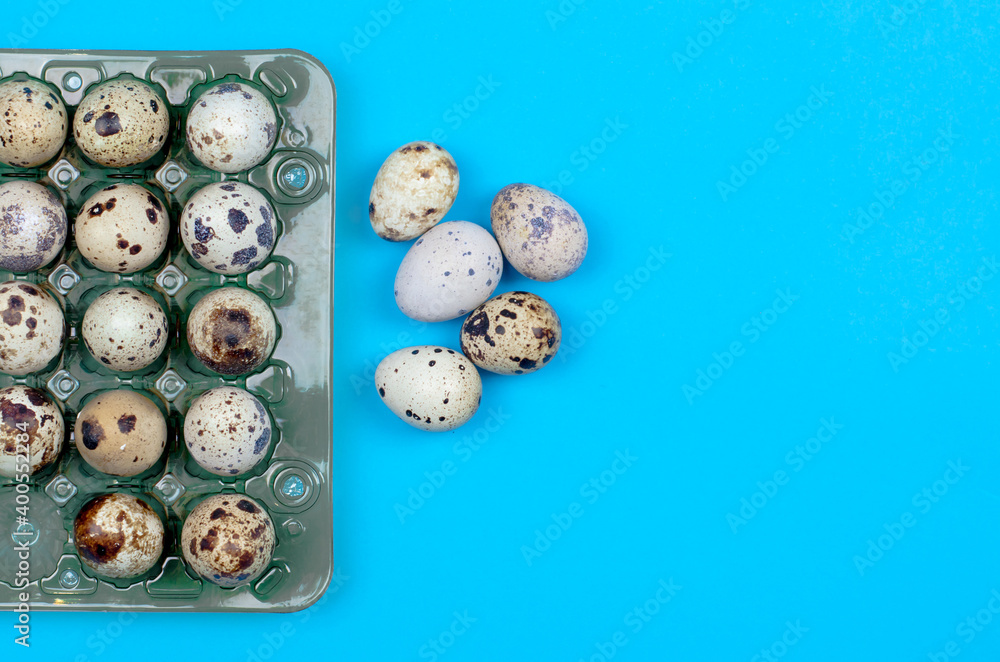 Quail eggs in a package on a blue background