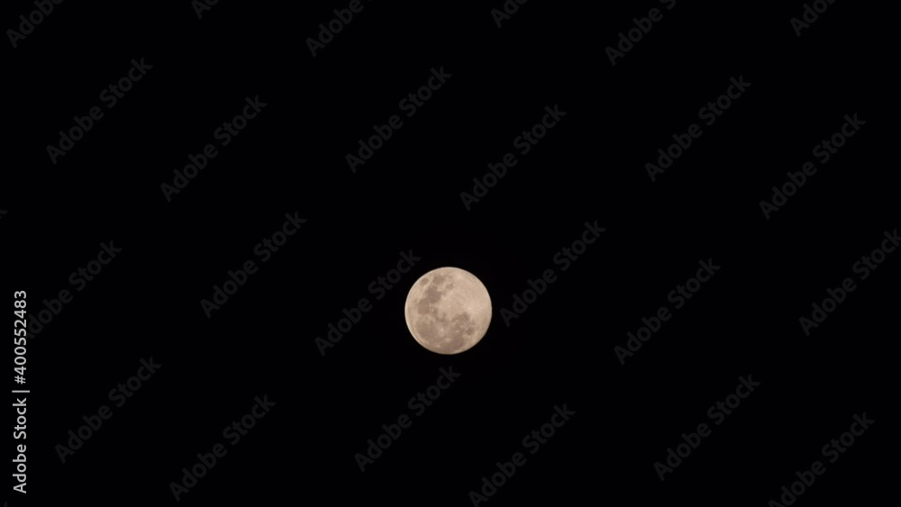 The moon is clearly visible with craters against the background of the night black sky The moon is clearly visible with craters against the background of the night black sky