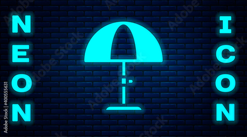 Glowing neon Sun protective umbrella for beach icon isolated on brick wall background. Large parasol for outdoor space. Beach umbrella. Vector.