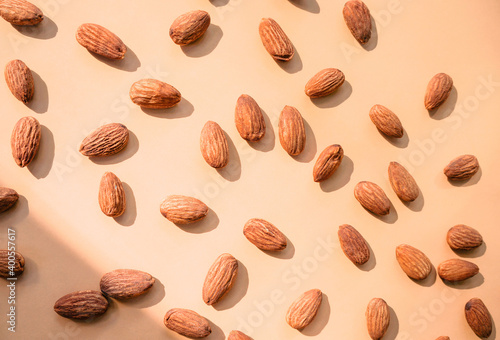 Tasty almonds on color background