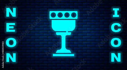 Glowing neon Medieval goblet icon isolated on brick wall background. Holy grail. Vector.