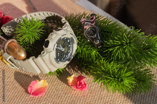 Universal background for Christmas and New Year greetings. Women's and men's wristwatches. Contrast size of women's and men's watches. Women's watches are small, with rhinestones, similar to jewelry. 