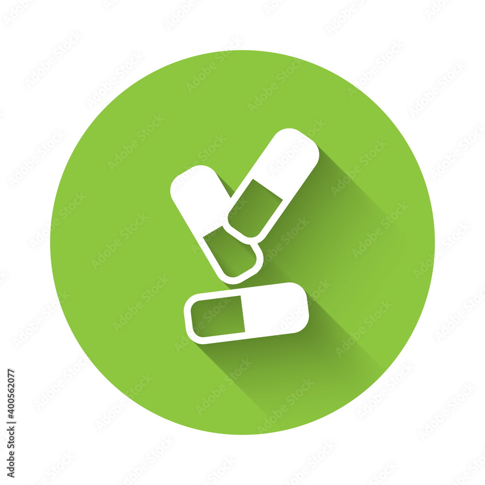 White Vitamin complex of pill capsule icon isolated with long shadow. Healthy lifestyle. Green circle button. Vector. White Vitamin complex of pill capsule icon isolated with long shadow. Healthy lifestyle. Green circle button. Vector.