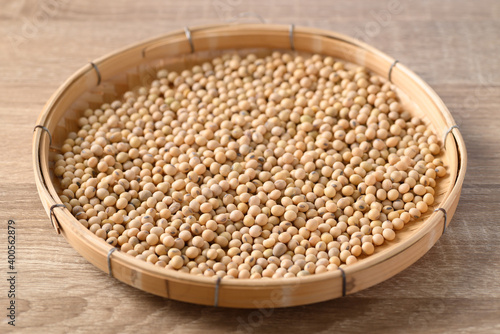 Soybeans seed in a bamboo tray on wooden background